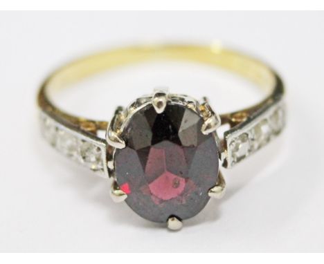 An 18ct gold purple stone ring, size M, gross wt. 3.2g.