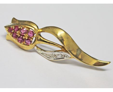 A 9ct gold diamond and ruby brooch, length 4.8cm, gross wt. 5g.