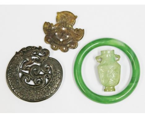 Two eastern hardstone pendants, a miniature jade urn and a glass bangle. Condition - general wear throughout.