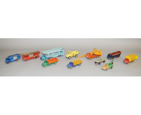 Eleven unboxed Dinky Toys diecast commercial vehicle models with varying degrees of play wear, including a 982 Bedford Car Tr