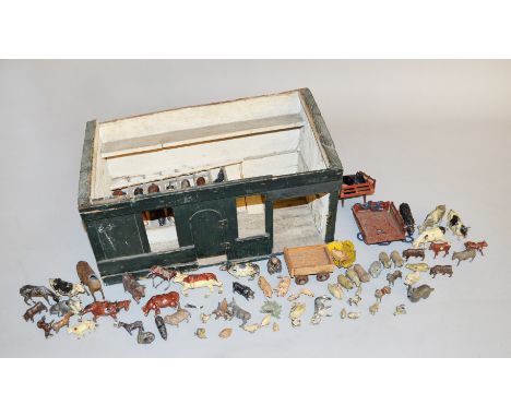A quantity of of playworn hollowcast farm and zoo animals by Johillco and similar, most damaged, contained in a homemade barn