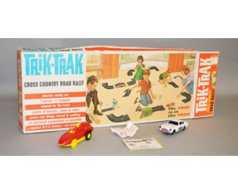 A boxed Tri-ang 'Trik-Trak' T.T.1 Cross Country Road Rally Set containing a red car, track and an unused press-out cardboard 