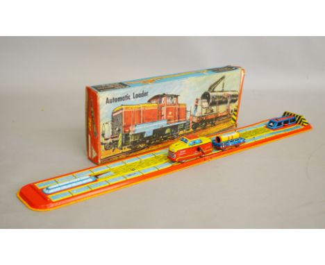 A boxed vintage tinplate clockwork Technofix (W. Germany) #297 'Automatic Loader model, containing folding tinplate track wit