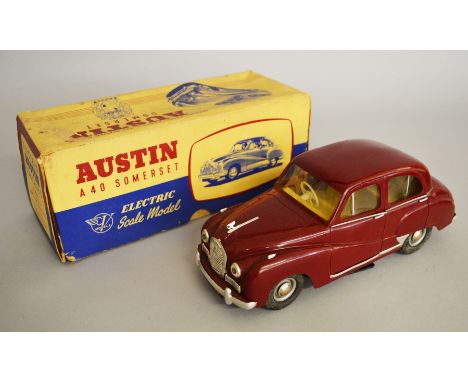 A boxed Victory Models Austin A40 Somerset plastic bodied battery operated model car in maroon, scarce colour, F but with cra