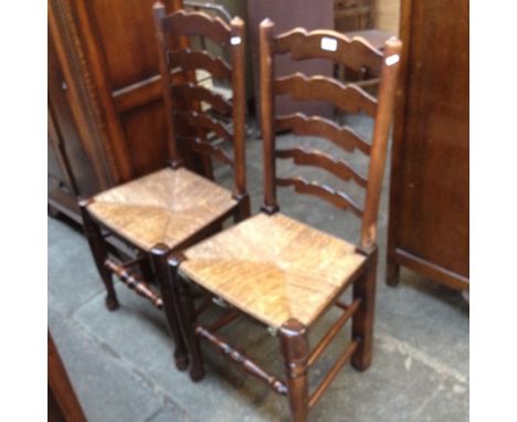 A PAIR OF LADDER BACK CHAIRS