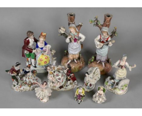 A pair of Continental porcelain figures of gypsy girls playing banjo, late 19th century, 24.5cm high, originally with candle 