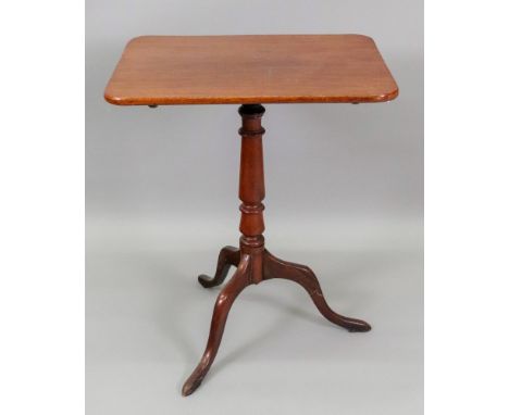 A late George III mahogany pedestal table, the rectangular tilt-top, on a baluster turned pillar and tripod base,57cm wide x 