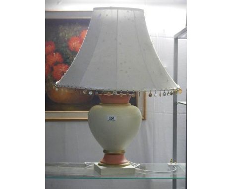 A ceramic table lamp with shade.