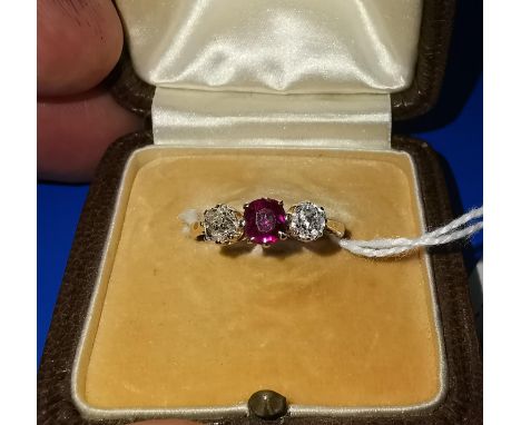 An 18 carat gold dress ring set ruby and 2 diamonds 