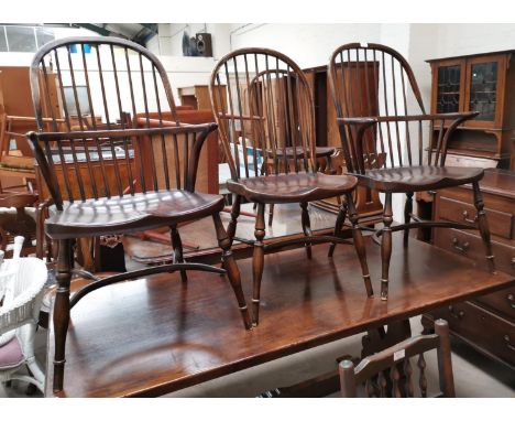 A set of 6 (4 + 2) Windsor style dining chairs, with stick backs, on turned legs with bow stretchers 