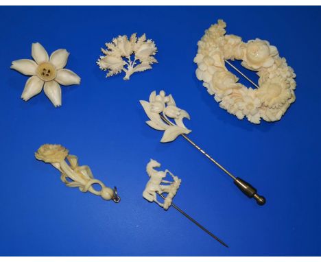 A 19th century continental carved ivory floral spray brooch; a lily-of-the-valley stick pin; 4 similar pieces 