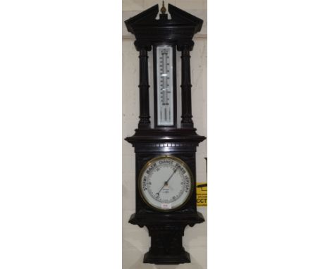 A late Victorian aneroid barometer with thermometer in architectural case with broken pediment, by Spikins, Guildford 