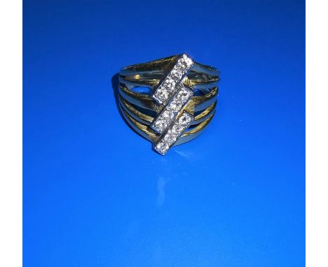 A yellow metal multi-shank ring set 3 rows of 4 diamonds at an angle, unmarked, tests as 18 ct, 6.6 gm 