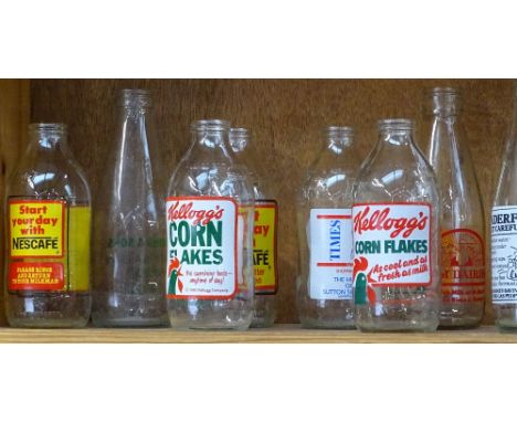 A shelf of 1980s advertising milk bottles, and dairy bottle 