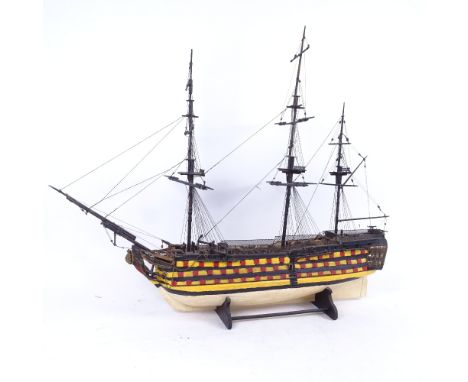 A handmade model of a 19th century first rate ship of the line, on stand, length 65cm, height 55cm 