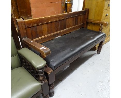 A stained hardwood and upholstered pub bench 