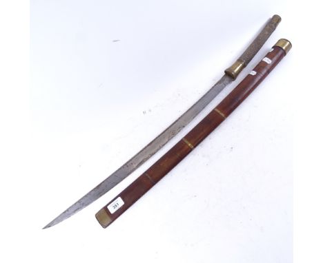 A Japanese katana sword, curved steel blade with shagreen grip and brass mounts, with hardwood scabbard, blade length 63cm 