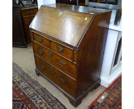 A Georgian oak bureau with fitted interior, 4 drawers under, on bracket feet, W76cm, H93cm 