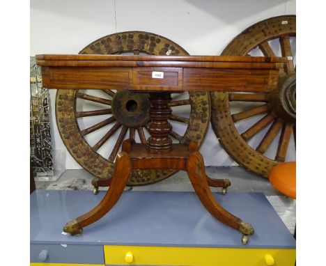 A Regency mahogany and ebony-strung fold over card table, on a turned centre column, and raised sabre leg base, W91cm 