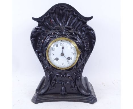 A 2-train mantel clock in carved ebonised case 