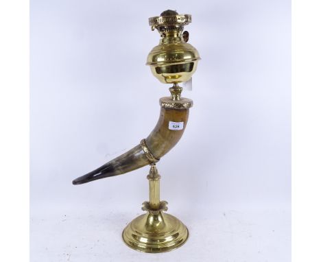 A brass and buffalo horn oil lamp, with opaque glass shade, height to top of shade 75cm 