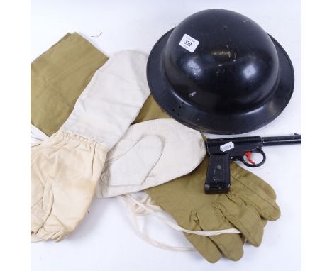 A Second War Period British Army Brodie steel helmet, Arctic climate mittens, a Gat air pistol by T J Harrington &amp; Son an