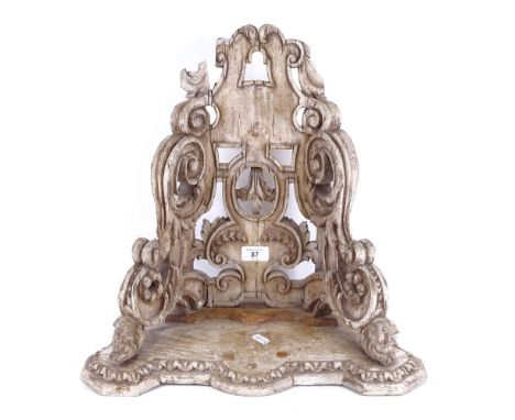 An Antique carved wood wall bracket, figural supports with fleur de lis emblem, overall height 42cm 