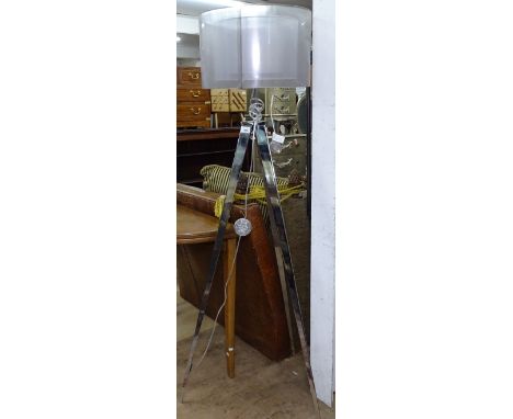 A contemporary design chromed standard lamp, on tripod legs 