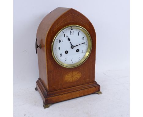 A French mahogany lancet-top 8-day mantel clock, satinwood inlay with brass mounts and white enamel dial with Arabic numerals