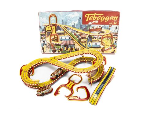 A Technofix No.290 Toboggan Tinplate Clockwork Toy, comprising colourful elevated track, two cars, in original box with warni