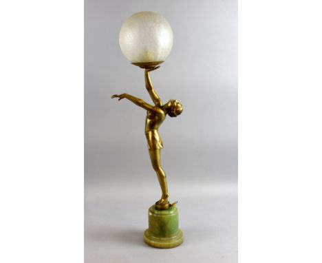  Art Deco spelter figural lamp of a dancing lady with, gilt figure,  crackle glass shade and a green alabaster base. 67.5 cm 