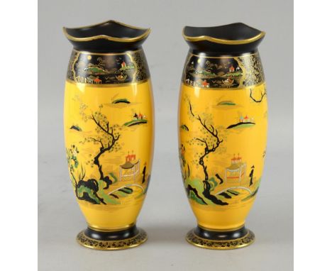 Pair of Carlton ware vases, with enamelled decoration of an Oriental scene on a  yellow ground vases, 21 cm   