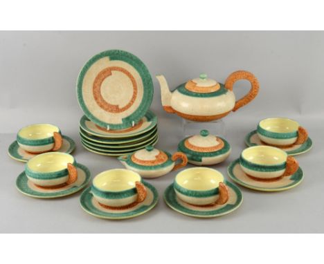 A stoneware tea-set, comprising teapot, sugar bowl, cream jug and six each of cups, saucers and side-plates, with green and b