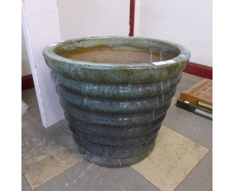 A large green glazed terracotta planter 