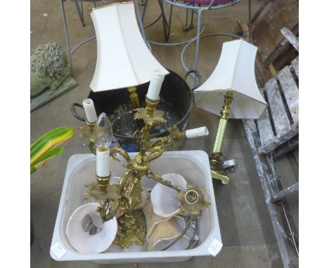 A gilt Rococo style table lamp on an onyx base and a pair of brass table lamps