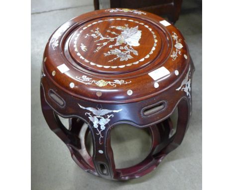 A Chinese hardwood and mother of pearl inlaid barrel shaped stool 