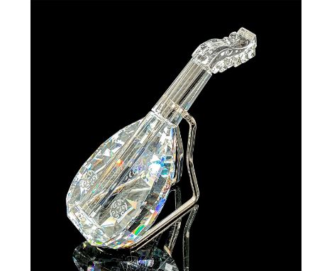 A clear figure of a string instrument with a rhodium metal stand. Swarovski mark. This item has its original box: 3.25"W x 5"