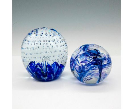 Cobalt blue mixed with controlled bubbles in clear glass. Smaller globe imprinted with WW has blue and raspberry swirl patter