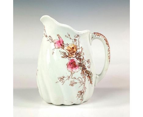 A small, Victorian style handled pitcher with transfer-print floral decorations and scalloped rim edge. Doulton Burslem backs