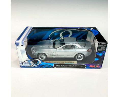 A factory sealed, replica die cast model car Mercedes-Benz in a silver exterior and gray interior. With moveable parts. This 