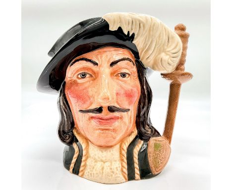 Variation One. Black hat, white feather, green tunic with gold trim. Under the banner of " All for one and one for all" Athos