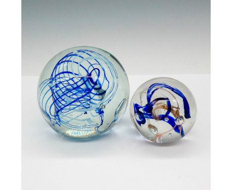 Clear glass globe with cobalt blue ribbon design in center. Artist signed. Small globe has ribbon design in cobalt blue and i
