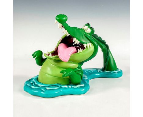 Porcelain wind up music figure with matte finish. Depicts the Crocodile from the 1953 animated film, Peter Pan. Makes a 'tick