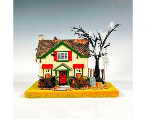 Home sweet, haunted home, featuring a twisted and gnarled spooky tree in the front yard, jack-o-lanterns in the windows, mini