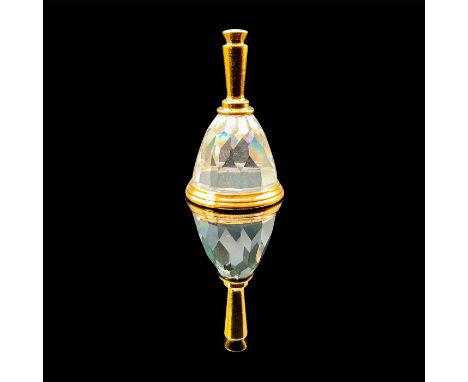 A clear faceted shaped bell with gold accents. This item has its original box: 3.5"L x 2"W x 1.25"H Artist: Nicole DunpontIss