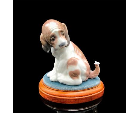 Adorable glazed, spotted puppy with butterfly on tail. Lladro backstamp. This item has a base included. Artist: Juan HuertaIs