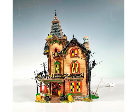 The Original Snow Village series, a ceramic figure in a semi-glossy finish. Depicts house decorated for Allhallows Eve with b