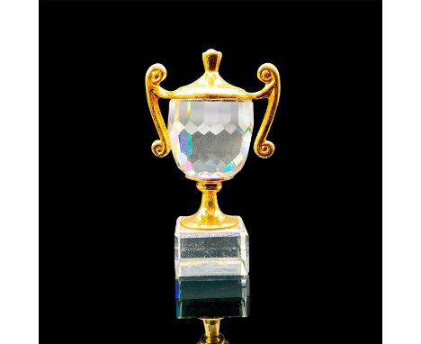 A clear faceted trophy with gold accents. This item has its original box: 3.25"L x 2"W x 1.25"H. Artist: Anton PoppingerIssue