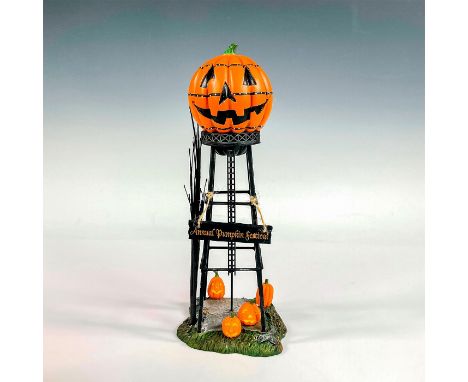 A ceramic village accessory in a matte finish. Depicts a spooky tower with a carved pumpkin on top and sign that reads 'Annua