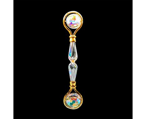 A clear handle rattle adorn with gold accents, and a rotating ball in the center. Swarovski impressed stamp. This item has it